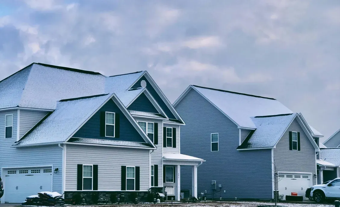 Ice and water shield installation on a Michigan roof during winter