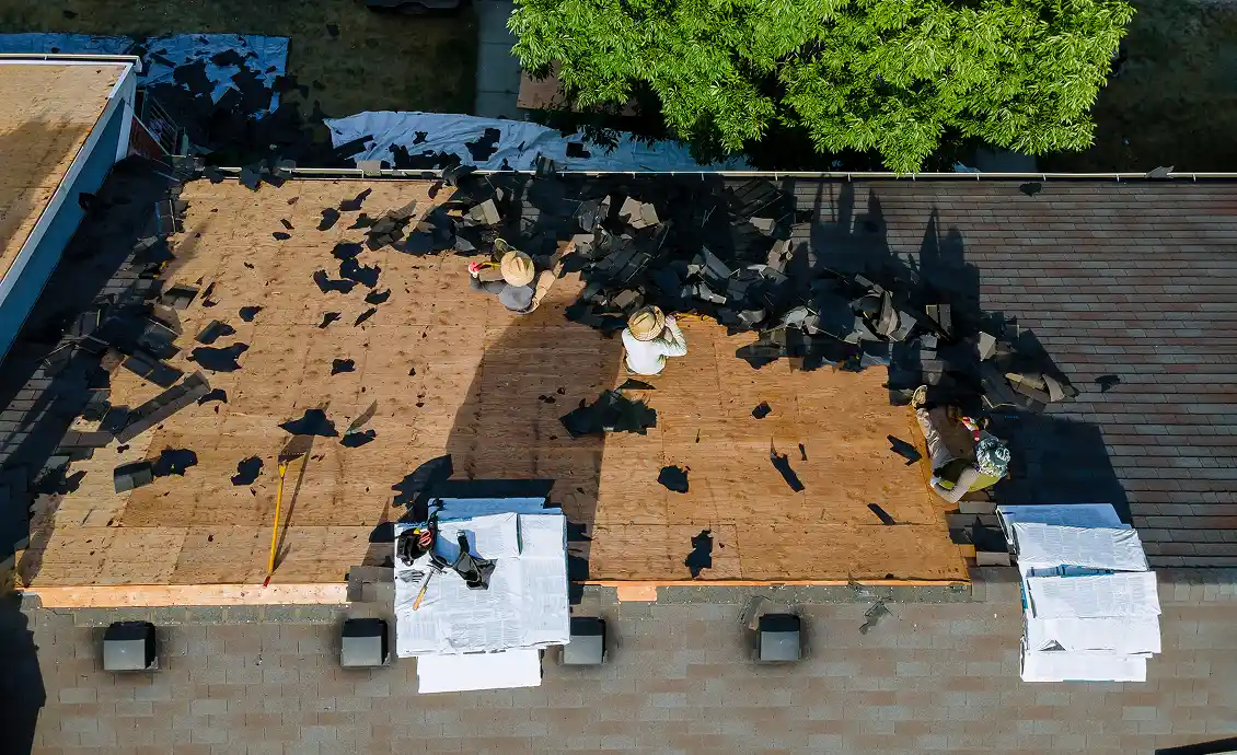 A roofing crew working on a residential roof replacement process in Cedar Springs, Michigan.