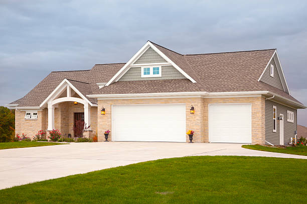 A Michigan home with temporary emergency roof leak repairs in place during heavy rain.